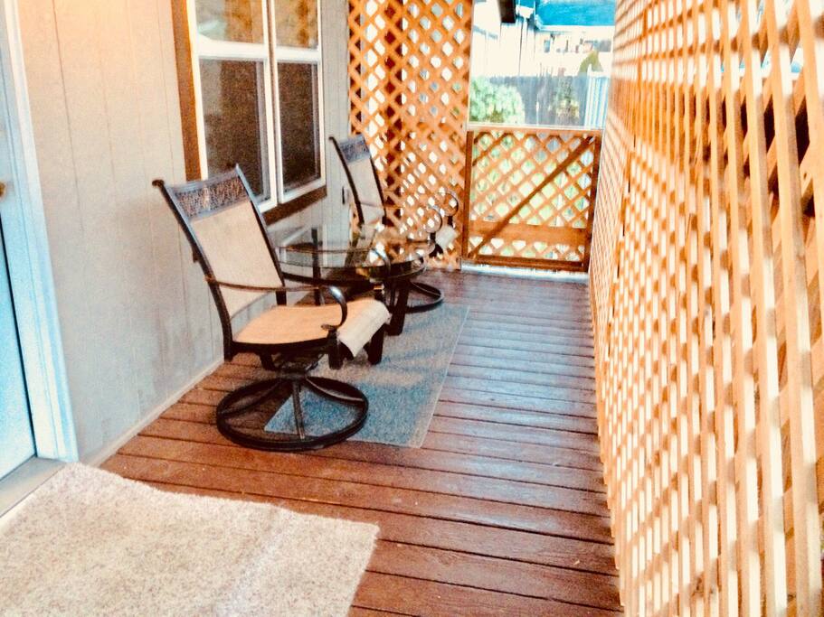 Front porch with privacy lattice. Smoking is permitted outside on porches. Please do not smoke indoors.