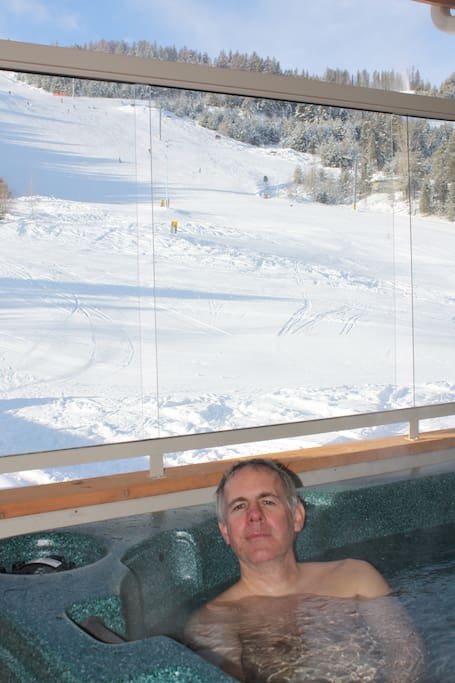 Watch the skiers while enjoying a soak.