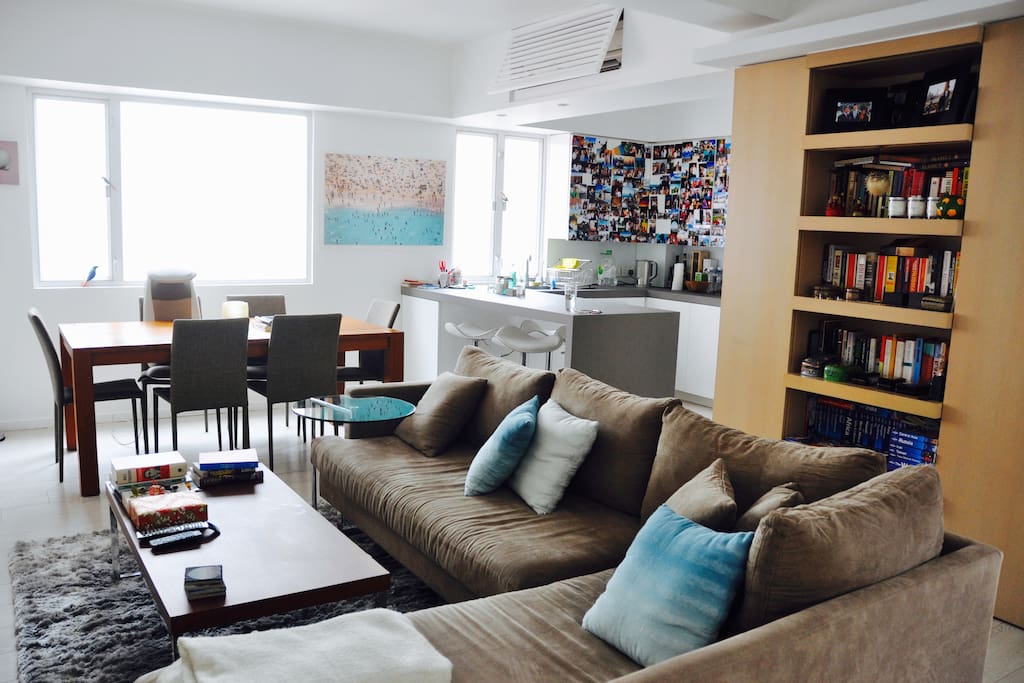 Main room with TV, couch, dining/ work table, kitchen island etc.