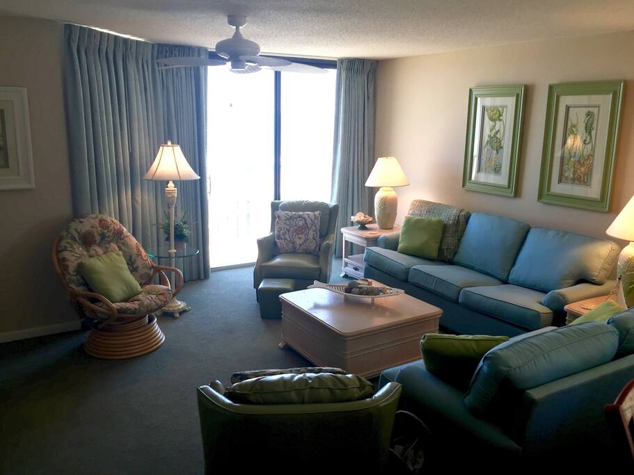Living room with the oceanfront balcony the length of the condo. (Corner condo too.)