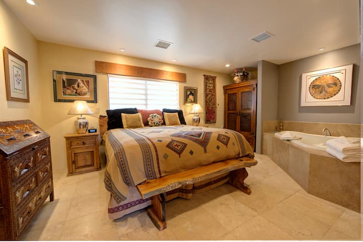 The guest bedroom has a king bed, armoire, iPod dock and spacious two-person jetted tub.
