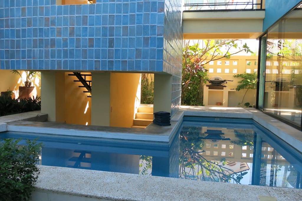 Pool wraps around two sides of tower staircase.