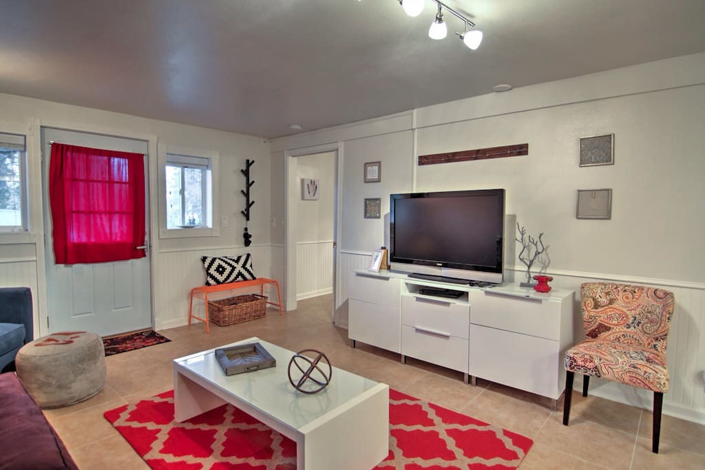 Brightly decorated living room adjoins the large bedroom (bedroom door just inside entryway).