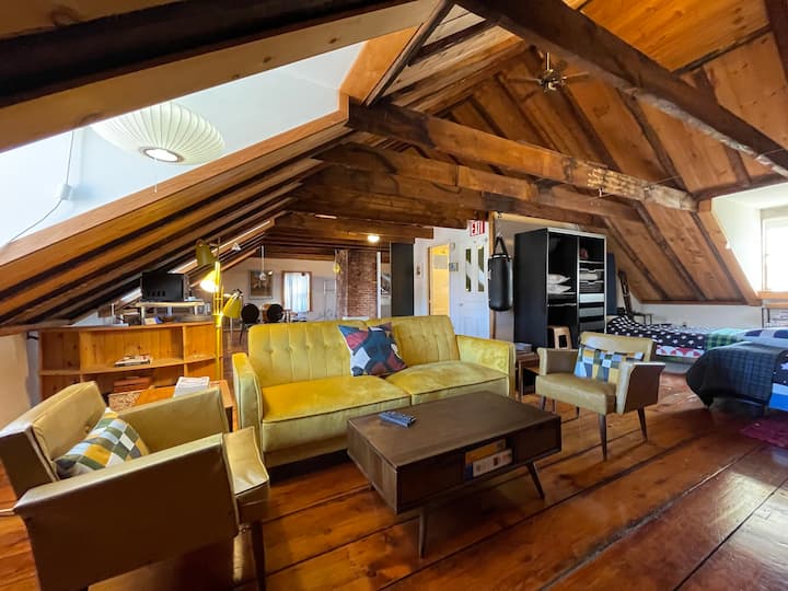 The interior of a historic Airbnb in Portsmouth has exposed wooden beams
