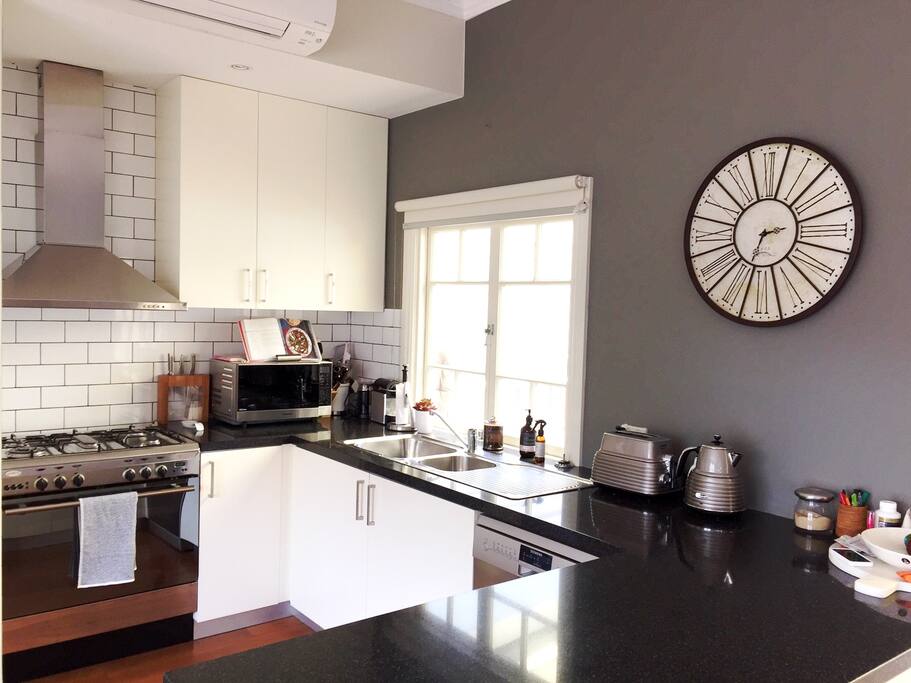 Kitchen with dishwasher, coffee machine and microwave