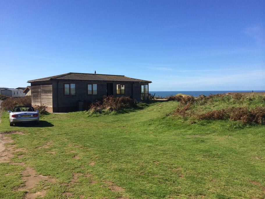 View of lodge from north side - area for parking. There are other units nearby but there is lots of space around ours