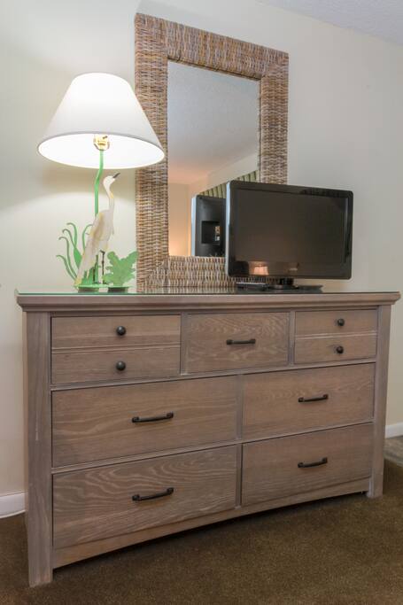 TV and dresser across from bed