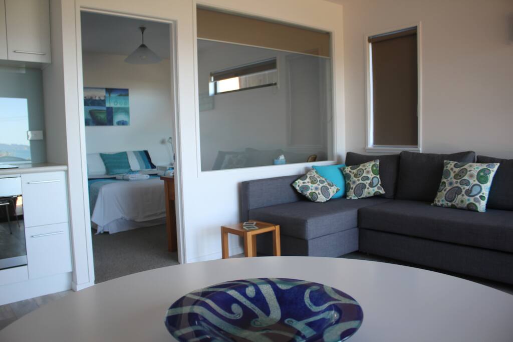 Dining and lounge area. View into separate bedroom.