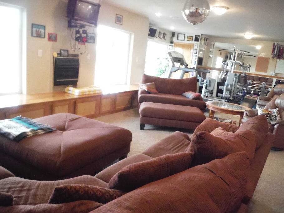 Bedroom opens to airy family room and home gym with mountain views.