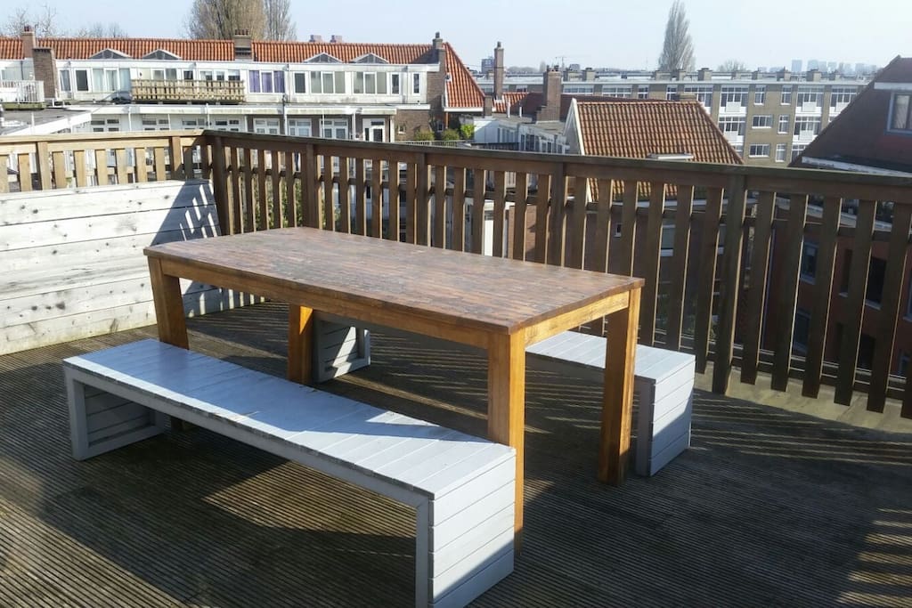 Table on roof terrace where you can sit and relax in the sun