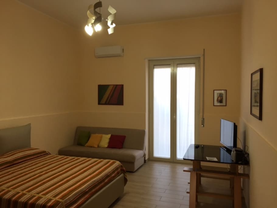 Master Bedroom (1 double bed, 1 sofa bed, Air Con, Wardrobe, TV, access to small terrace)