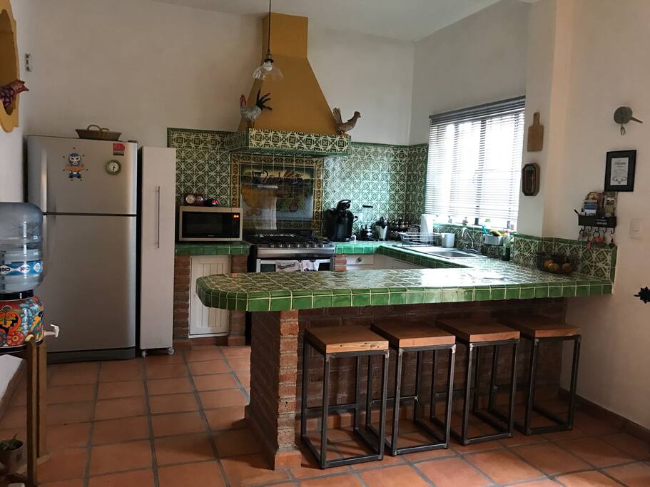 Open tiled bright kitchen makes cooking and entertaining super enjoyable! Grab a seat at a hand forged in SMA stools at the kitchen counter.