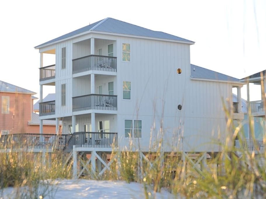 South-side of home. There are 4 private balconies off the master bedrooms which over amazing unobstructed gulf views.