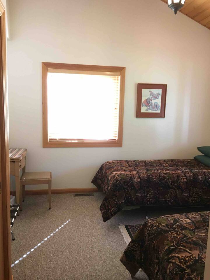 Main floor bedroom, just inside entry foyer, twin beds convertible to king bed for couples. No stairs and is the most accessible room.