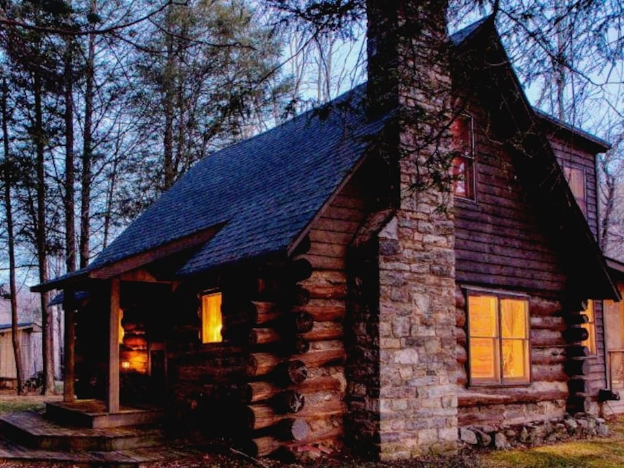Cabin: This is the cabin in late fall at dusk. From this view, you can see the living room windows on the bottom floor, two bedroom windows on the top floor and the screened porch at the rear.