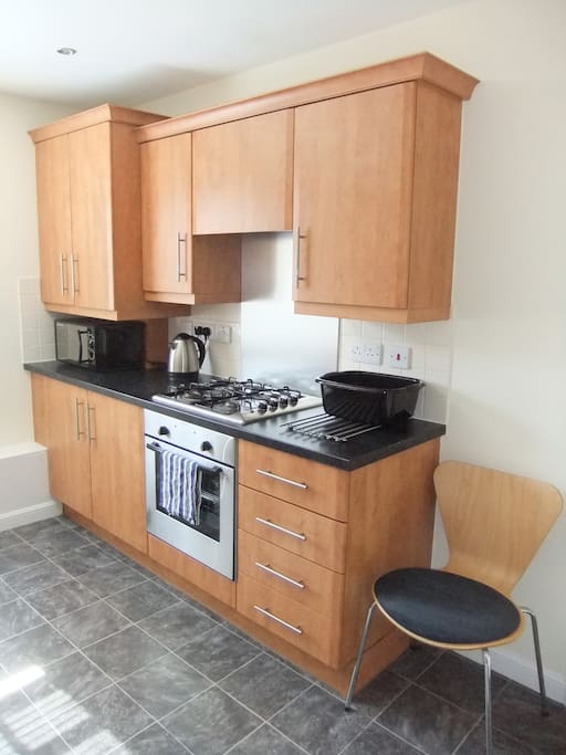 Kitchen also includes microwave, gas hob and large refrigerator.