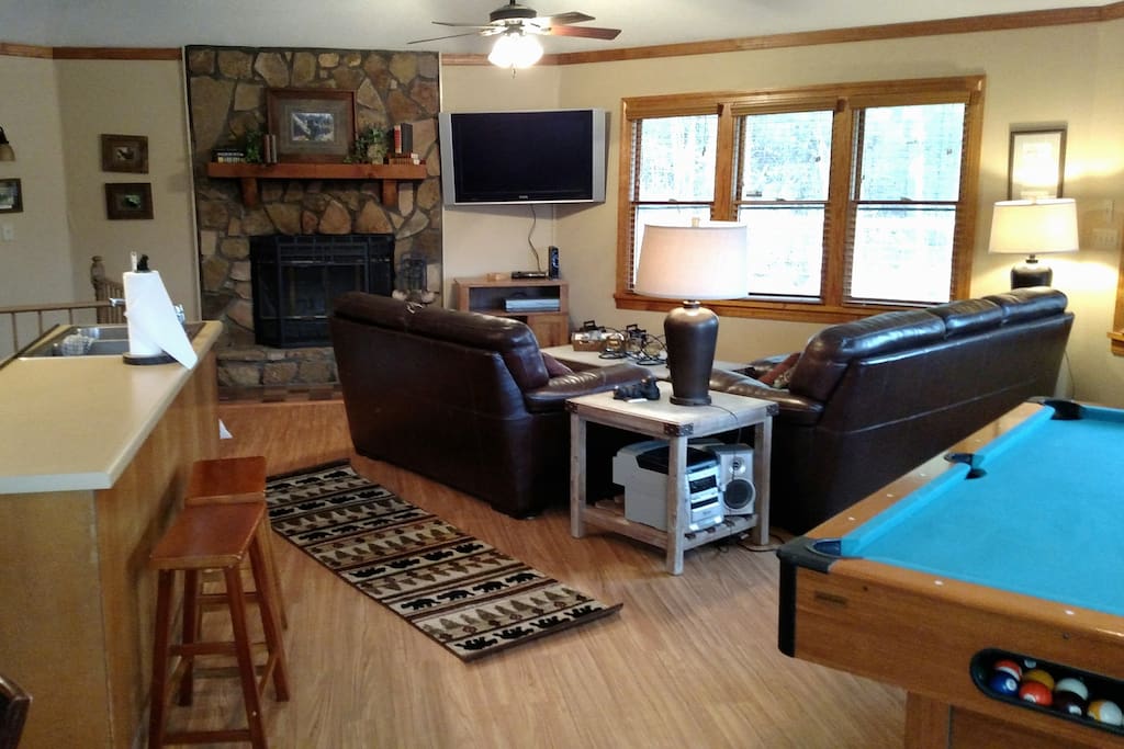Great room area with fireplace, tv and Pool table