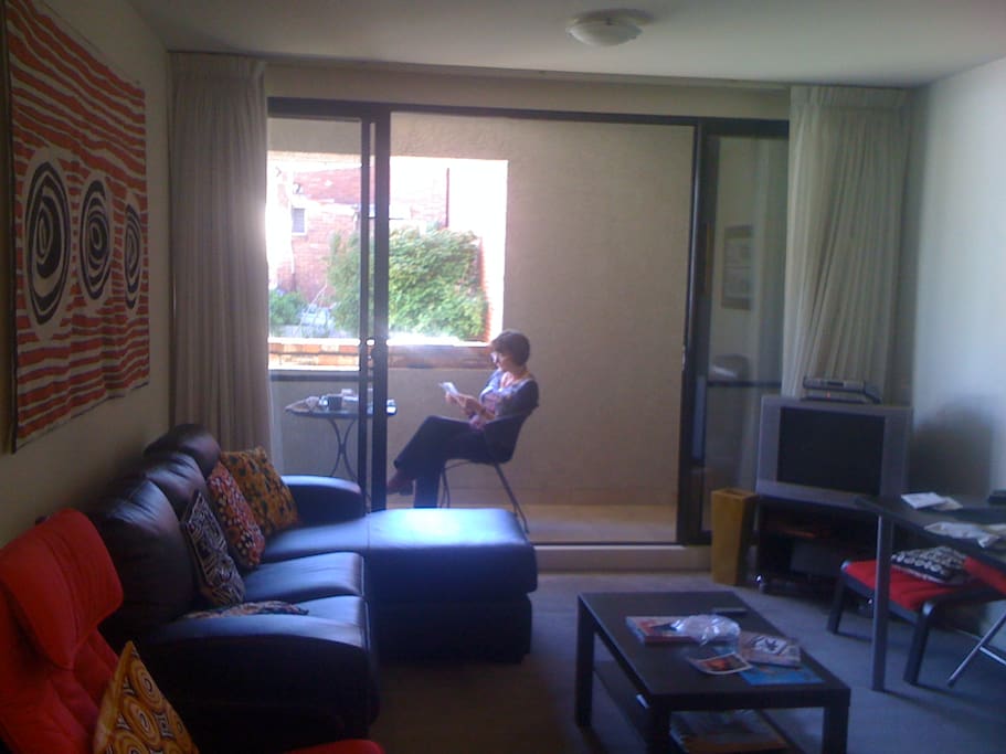 Lounge room with NBN internet TV looking out to balcony-overlooking Pinkys Lane, but one level up.