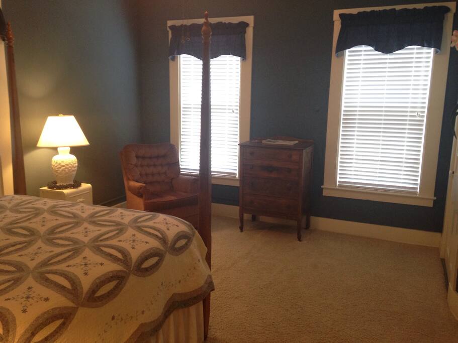 Large, spacious room with seating, a dresser, and closet space.