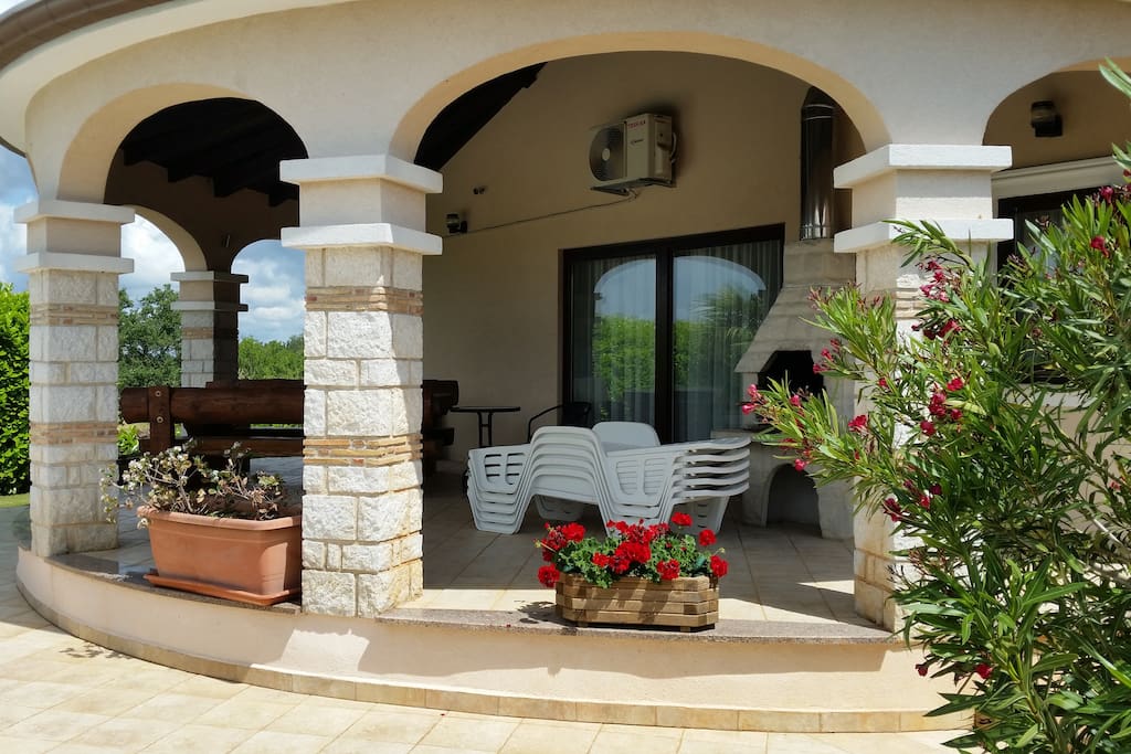 Terrace with wooden table and BBQ