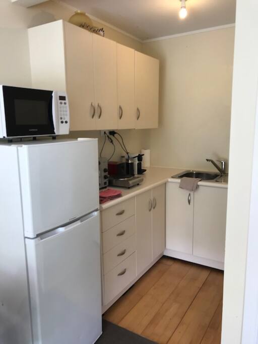 Generous Kitchenette, with Full sized Fridge and Freezer, Storage, Nescafe Espresso machine, microwave, bench top oven and 2 ring cooker. Stocked like a motel room, with Continental Breakfast things (Ceral, yoghurt, fruit, milk Toast with spreads, Coffee and Tea) and the basics for making meals.