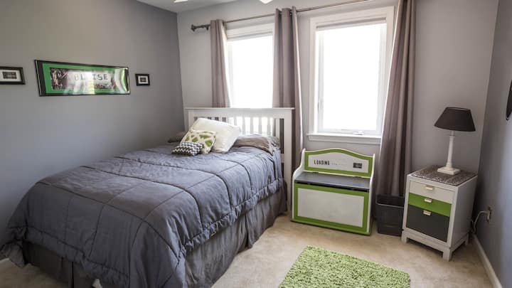 One of the bedrooms upstairs. It has a Dresser and end table. 