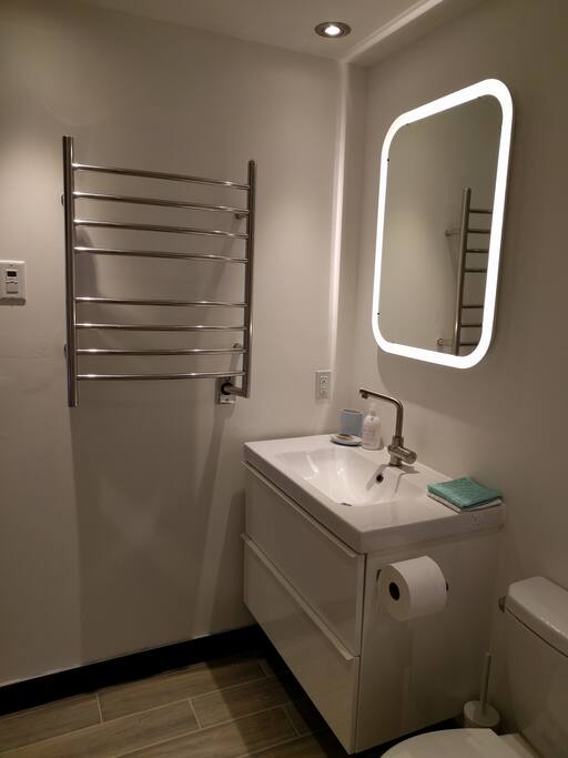 Heated Flooring and Towel Rail in Bathroom. The Sink Drawers have plenty of Storage.