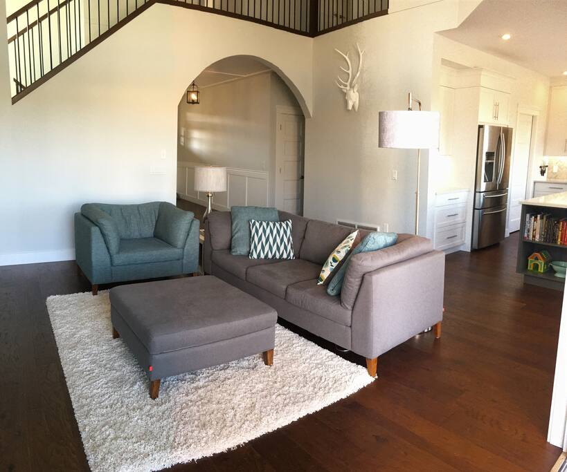 The main floor is open and airy, with vaulted ceilings and a light, beachy feel