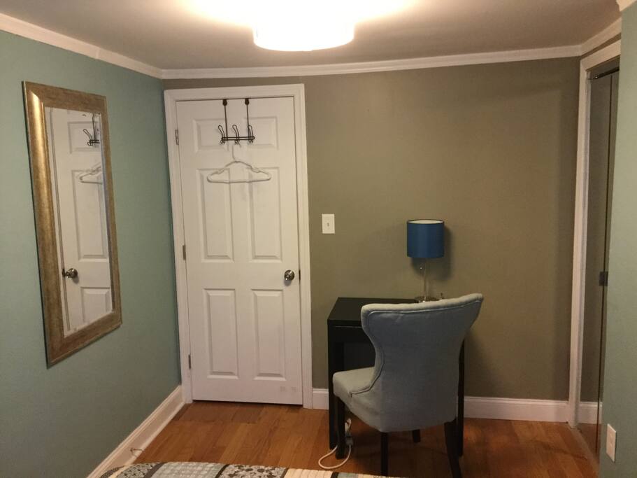 A nice chair and table with a well detailed lamp close to your bed to a quick check of your emails before bed.