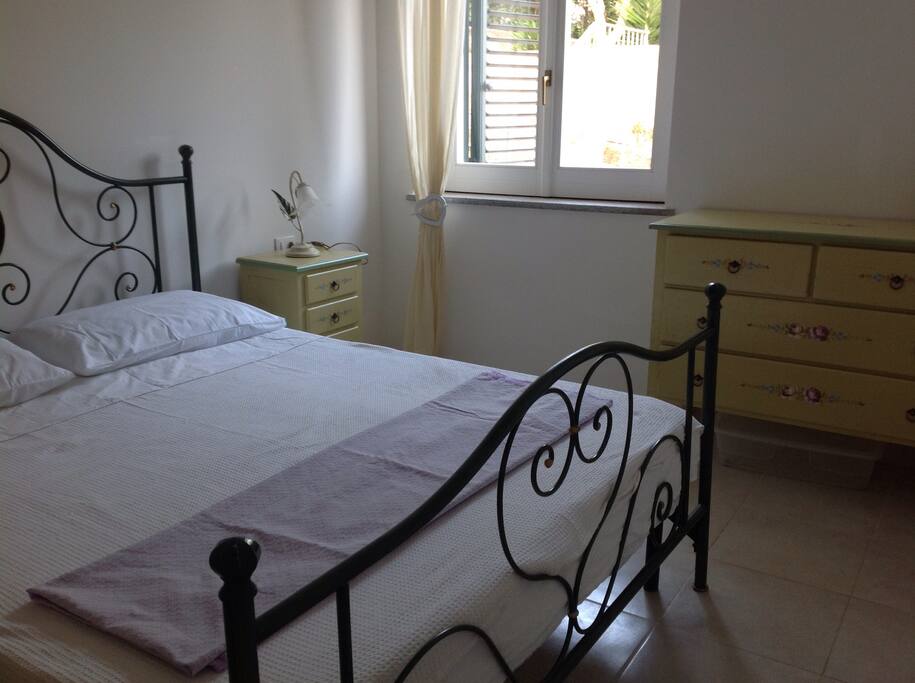 Beautiful bed and hand painted Italian furniture in the bedroom