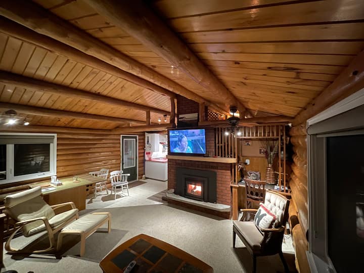 غرفة معيشة بها موقد خشبي جديد. 