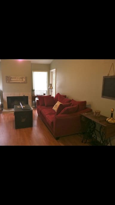 Very comfortable couch in front of a wood burning fireplace!