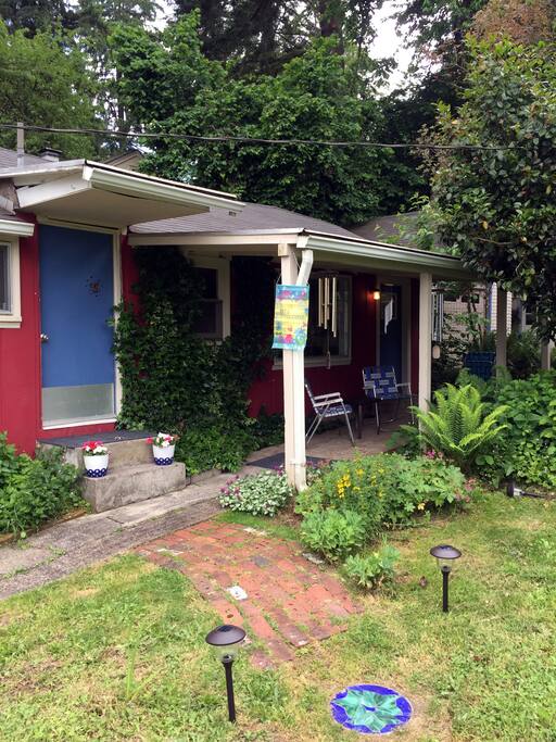 Cross the porch to the door.