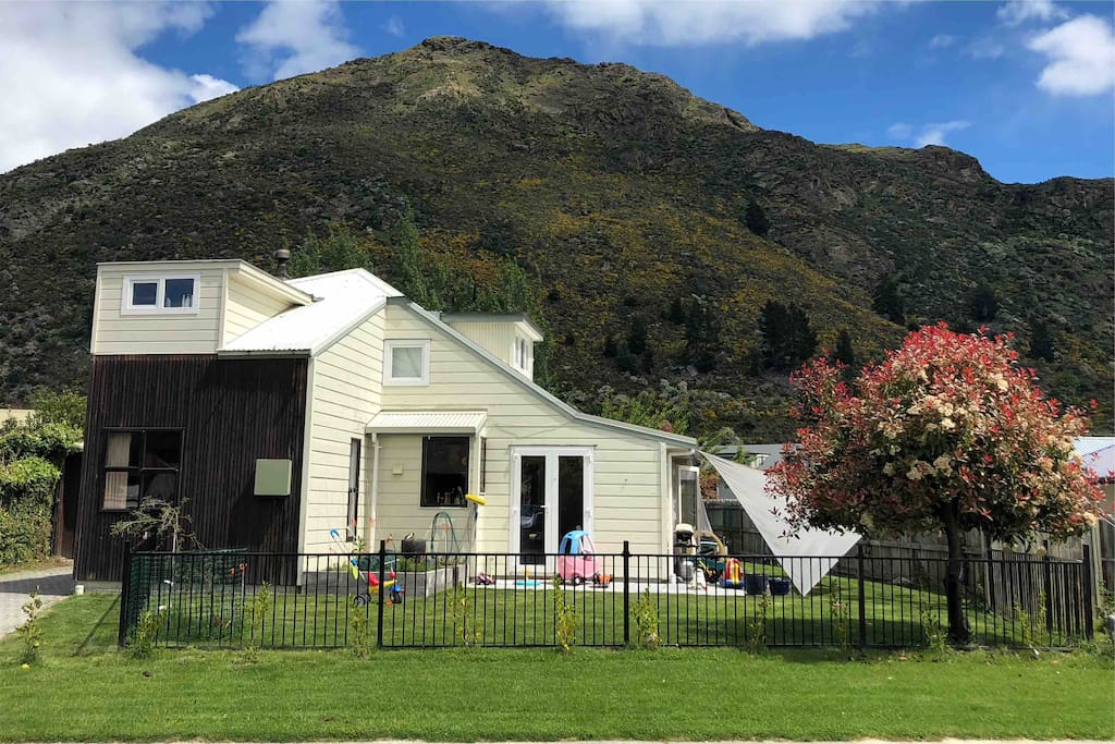 Street view of our house garden and driveway. Section fully fenced. Not the prettiest of houses but very functional and lots of toys for kids to play with.