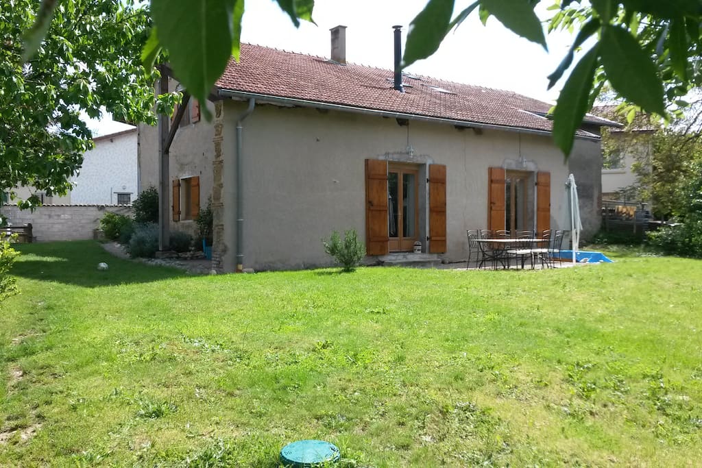 espace vert de 600m² derrière la maison avec une grande terrasse et une table ext 8pers
