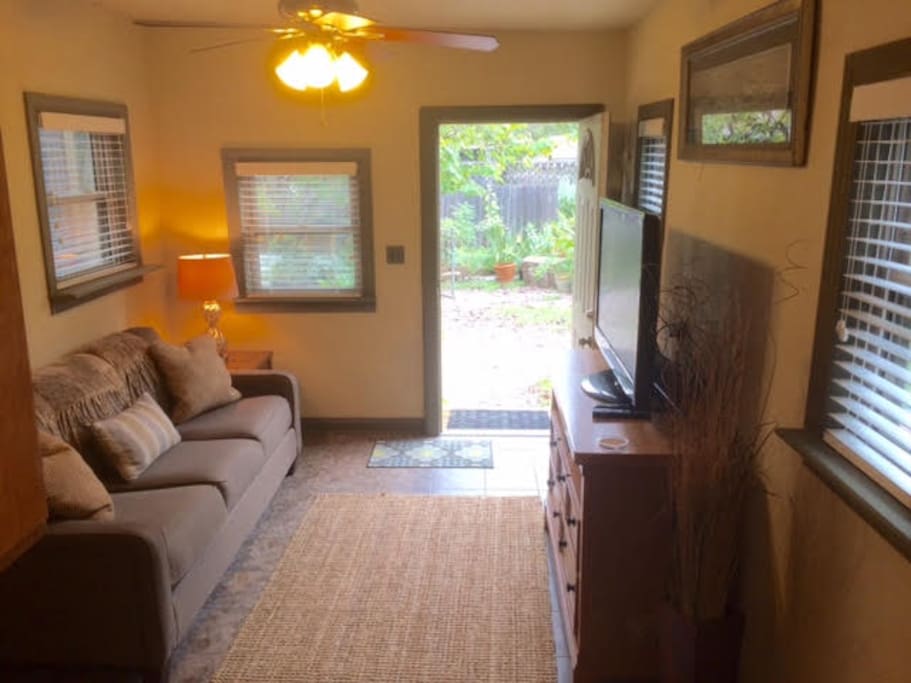 Living room area; as you can see, lots of natural light. New couch! Big Screen TV with a ROKU3.