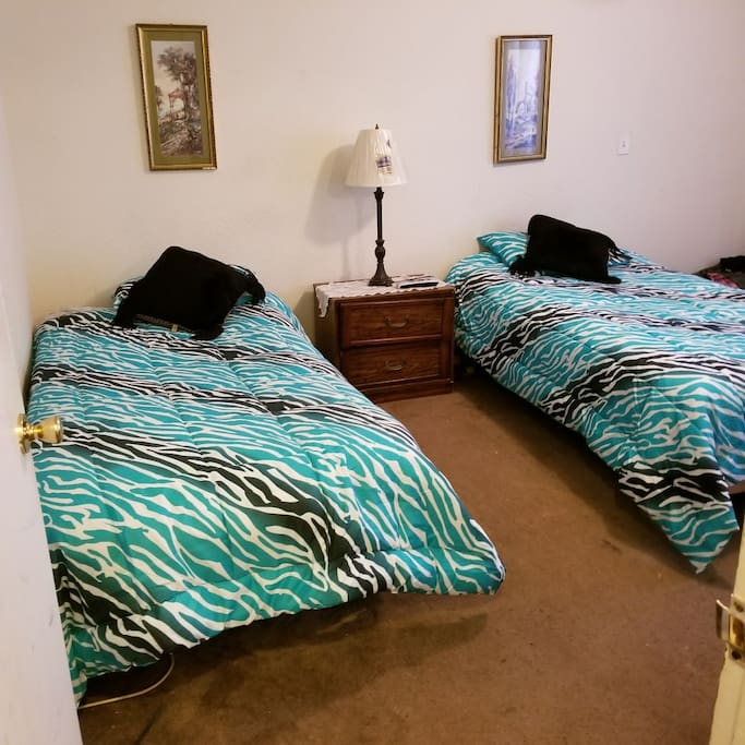 This photo shows twin beds it also
has access to backyard, and tv