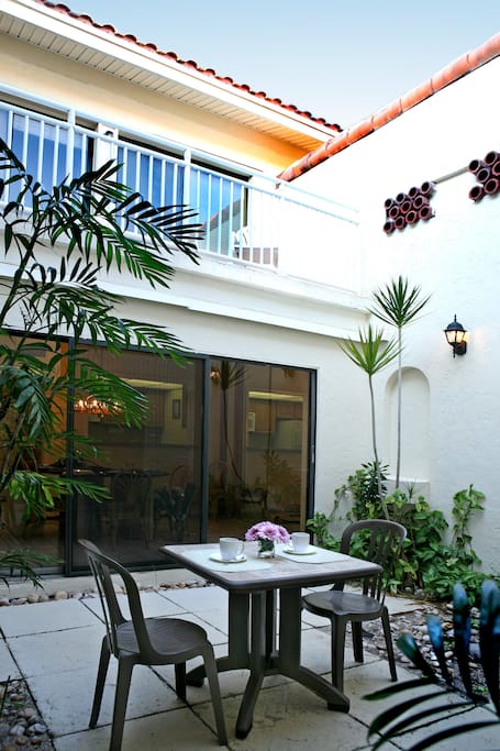 Each unit has a private courtyard on the first floor and balcony on the second floor with patio furniture.