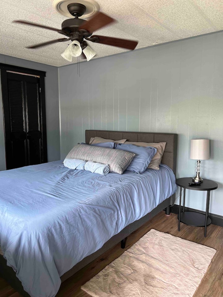 Primary Bedroom. 
Queen-size bed, private bathroom with shower, and private TV. 
Full view of the beautiful Weeki Wachee to wake up to.
This room also has a door that takes you outside to the deck.