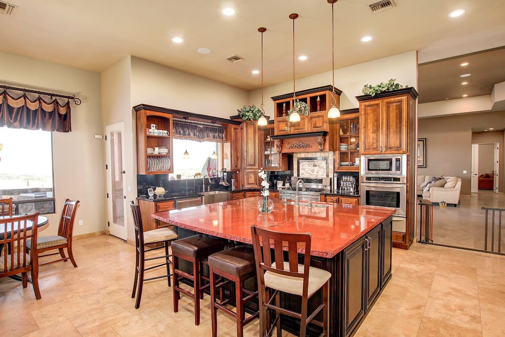 8' Red granite island, 3 sinks, 2 ovens, microwave, warming drawers, 3 drawer cooler, 6' frig/ freezer