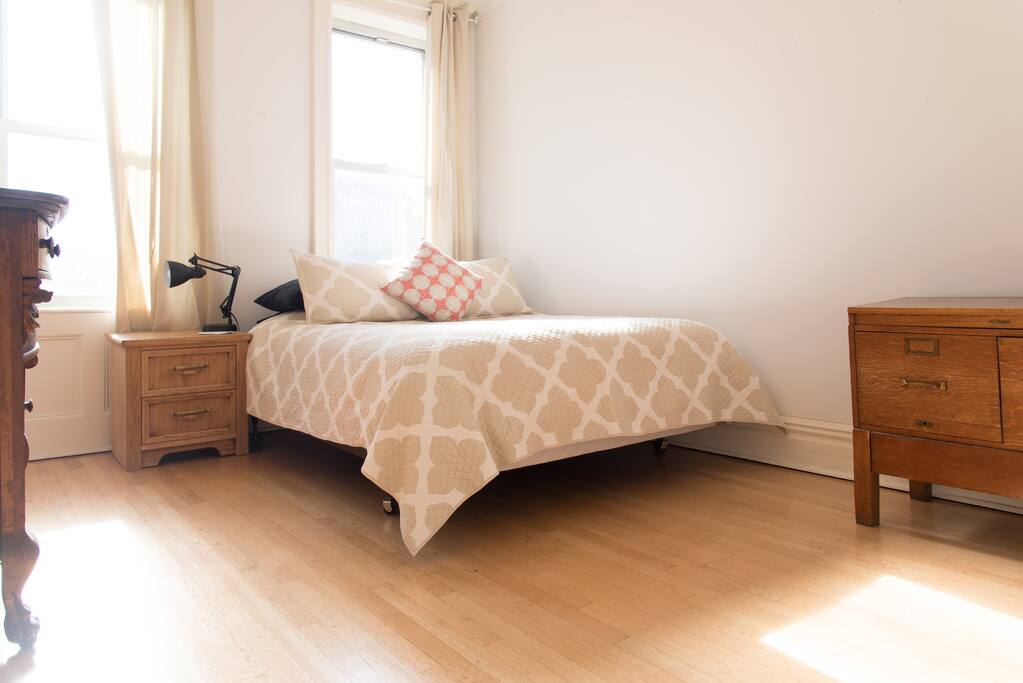 Master bedroom with queen size bed and antique wood dressers