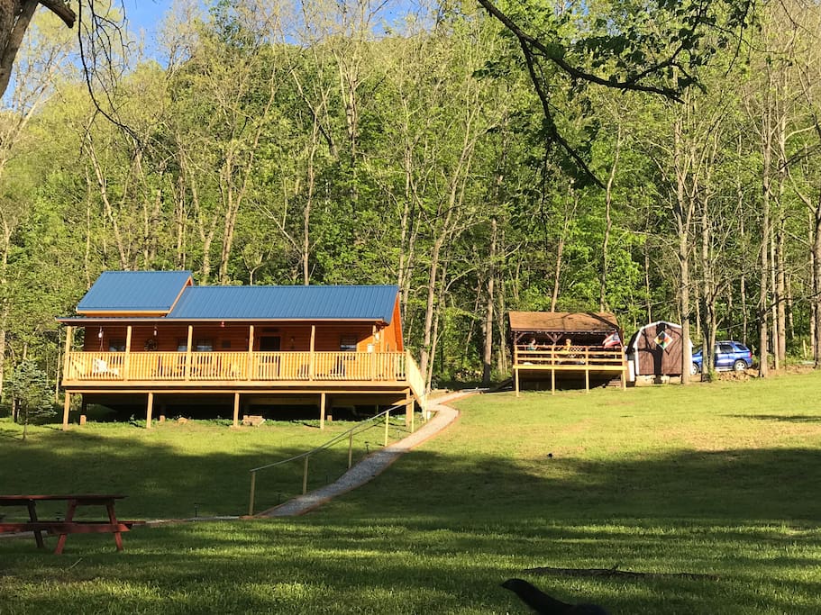 The cabin sits on 1.8 acres with 90 yards of water frontage. Up behind the cabin is a covered shelter house with dining area and gas grill with an open deck in front.