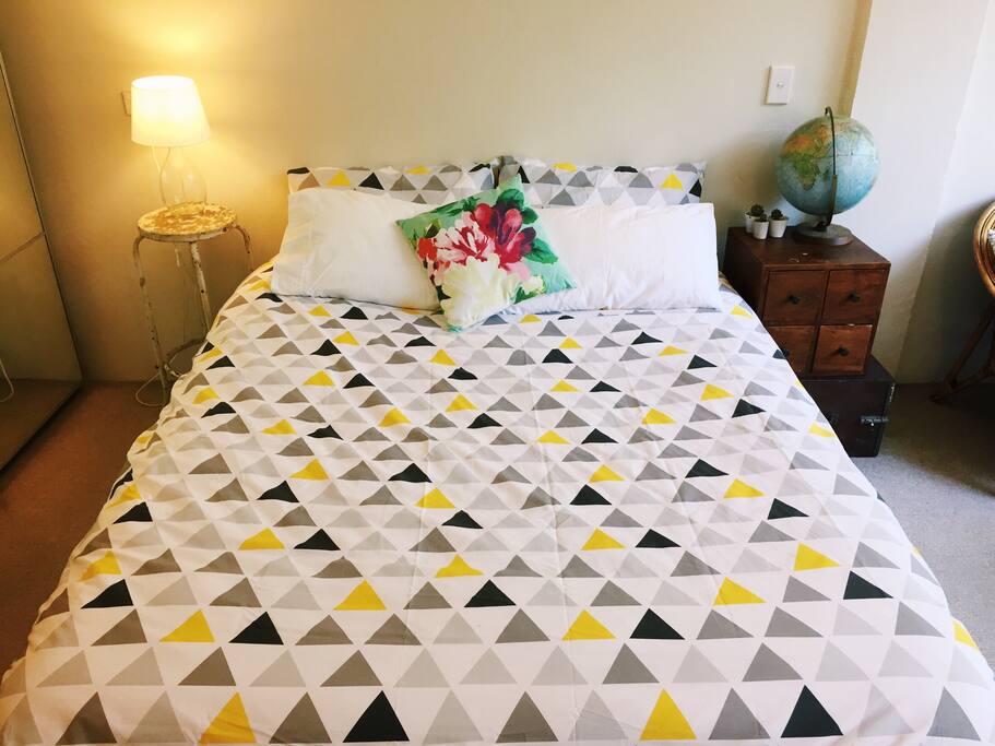 Crisp, fresh sheets on a comfy bed with lots of pillows.