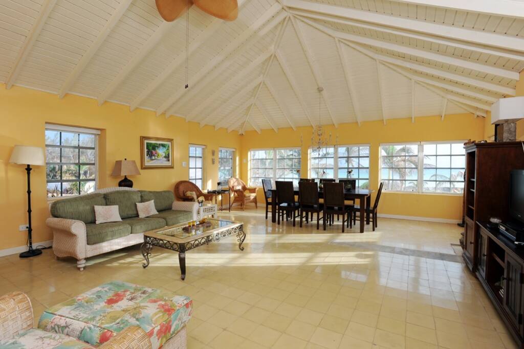 Living/dining room with a wall of ocean views