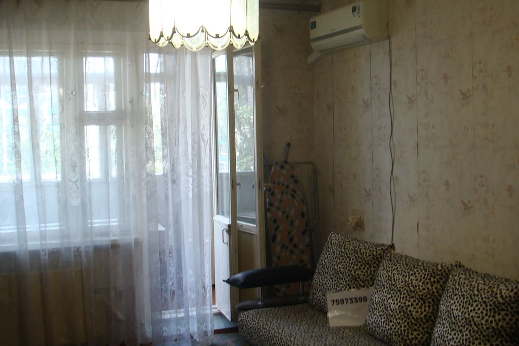 Large room with sofa and air conditioning.