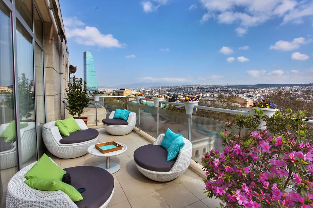 private terrace with panoramic views and colorful flowers