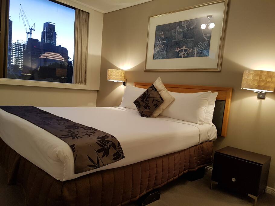 Bed room with park and city skyline views
