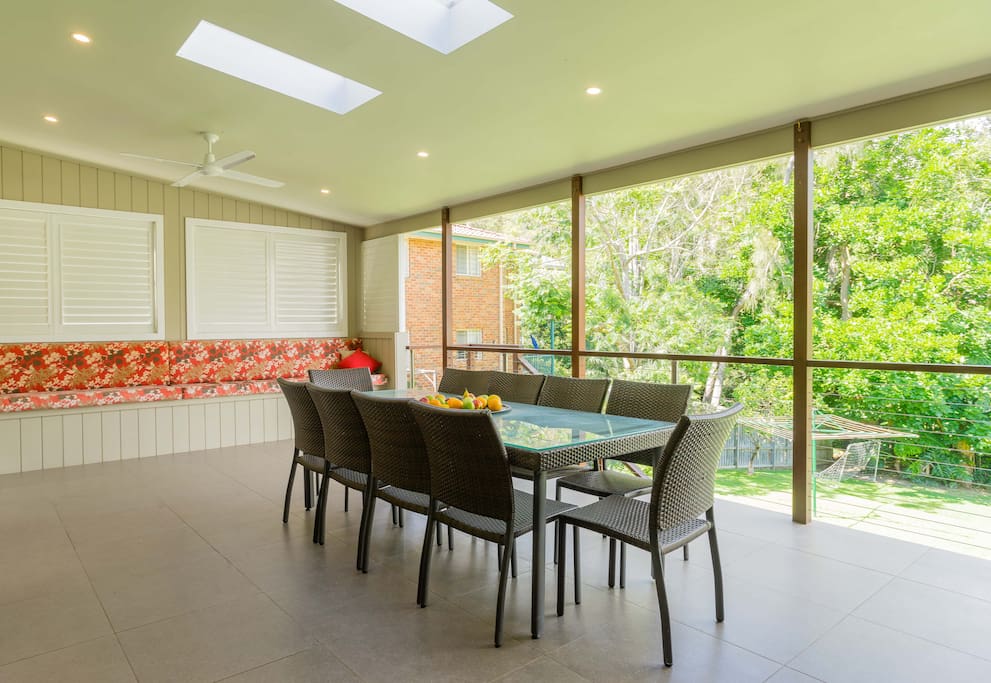 Large covered private entertaining deck overlooking spacious backyard.