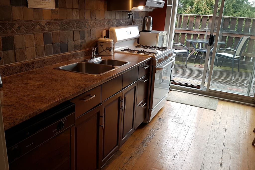 Bright kitchen with gas stove and dishwasher