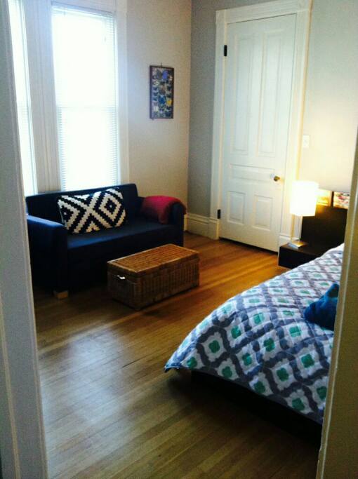 Small couch in bedroom by the windows for enjoying your morning coffee!